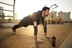 Man doing push ups to prepare for National Golf Month.