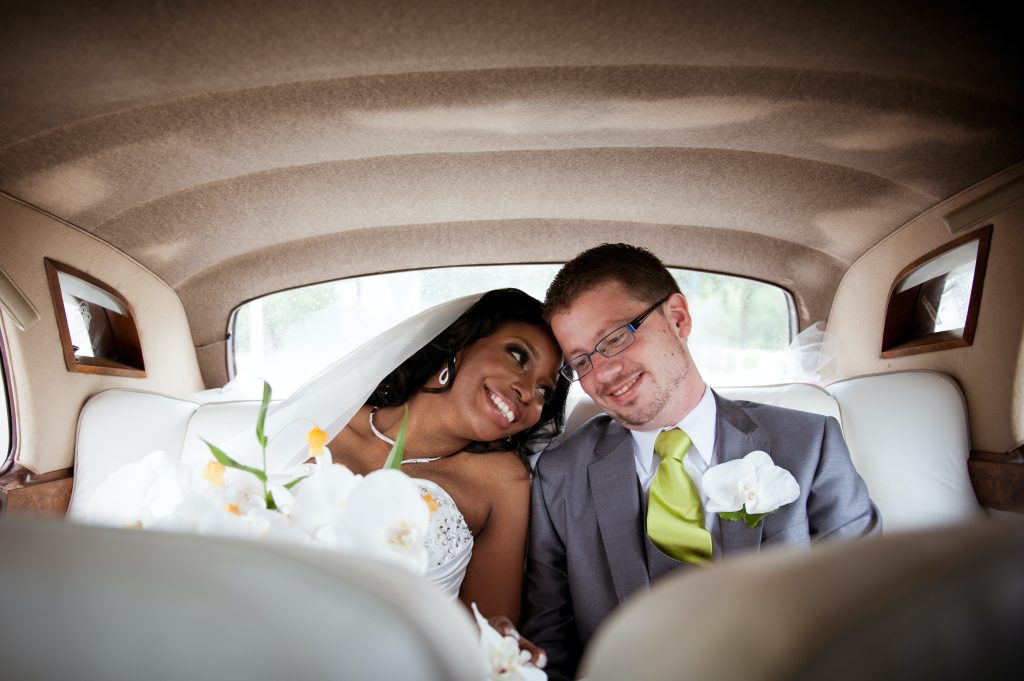 A bride and groom smile in a car. The Florida Wedding Expo will bring tons of happy couples to the OCCC.