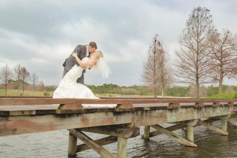 Bride and groom by Shingle Creek, at the Rosen Shingle Creek wedding venue